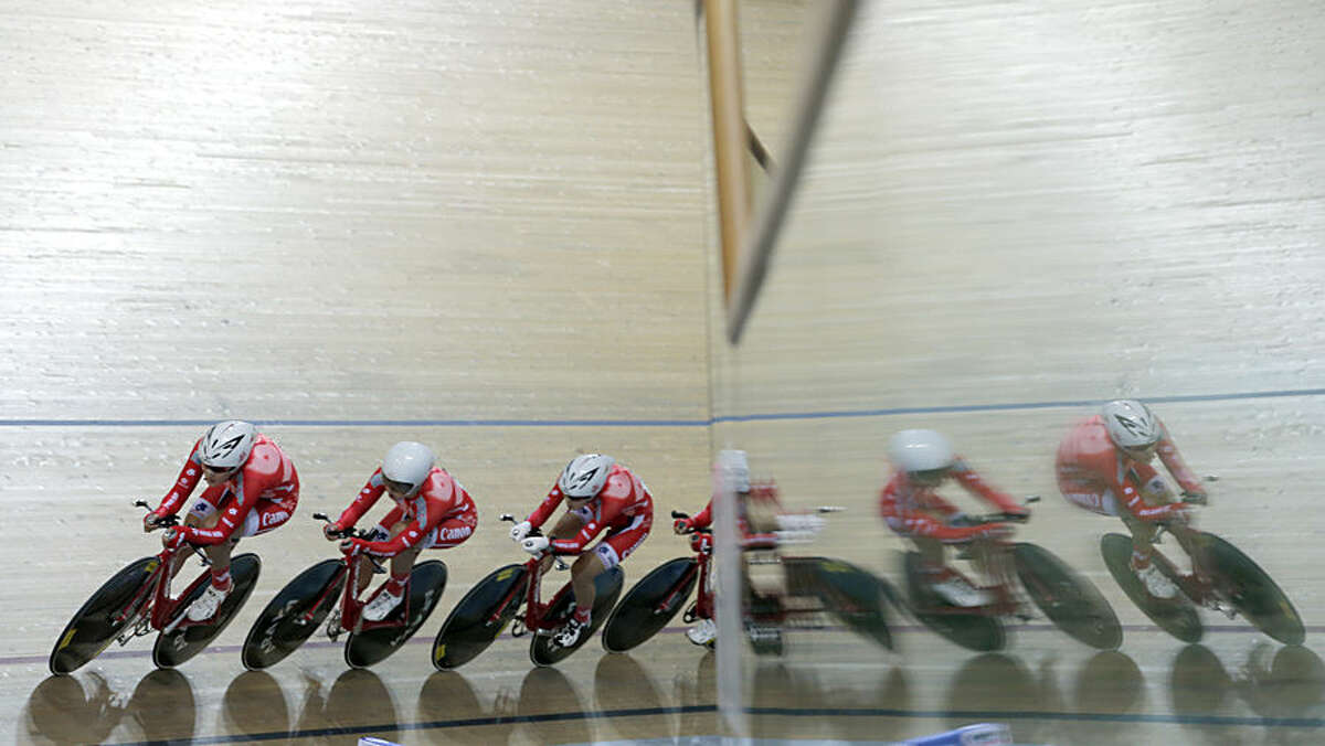 Honk kong team compete during the Women's team pursuit qualifying race at the Track Cycling World Championships in Saint Quentin-en-Yvelines, outside Paris, France, Wednesday, Feb. 18, 2015. (AP Photo/Christophe Ena)