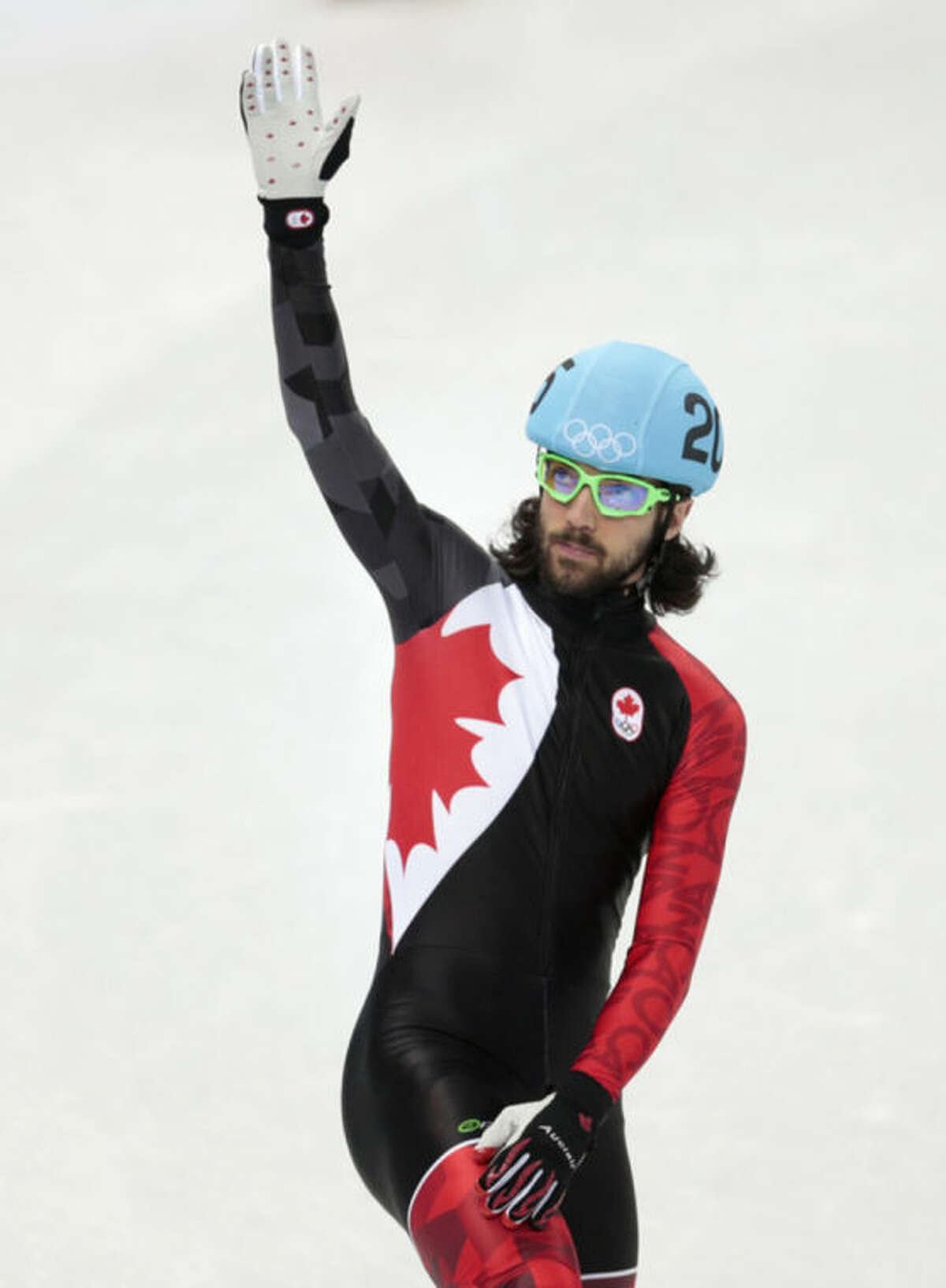Charles Hamelin of Canada waves to spectators after competing in a men's 1500m short track speedskating semifinal at the Iceberg Skating Palace during the 2014 Winter Olympics, Monday, Feb. 10, 2014, in Sochi, Russia. (AP Photo/Ivan Sekretarev)