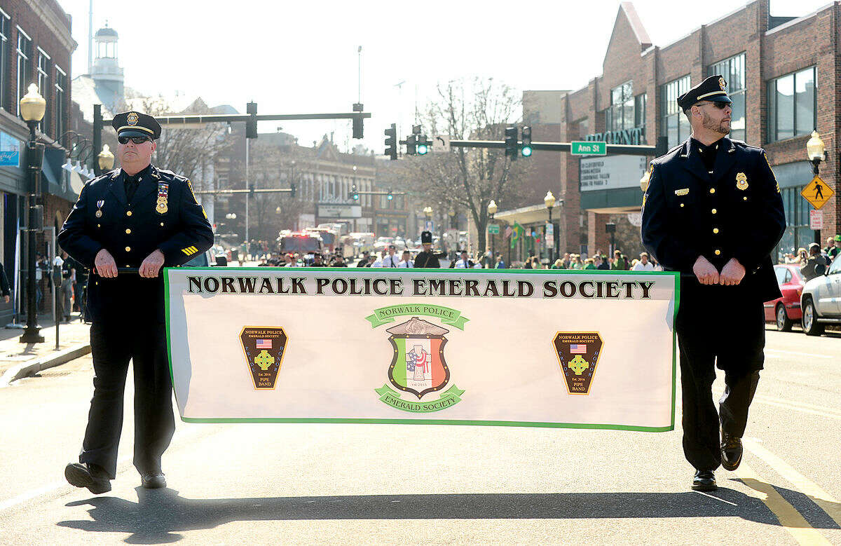 Hour photo / Erik Trautmann The Norwalk Police Emerald Society leads the first Norwalk St. Patrick's Day parade Thursday which made it's way down South and North Main Streets ending at O'Neill's Pub.