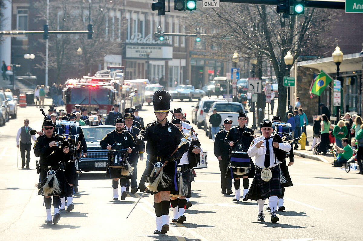 Hour photo / Erik Trautmann The Norwalk Police Emerald Society Pipe Band leads the first Norwalk St. Patrick's Day parade Thursday which made it's way down South and North Main Streets ending at O'Neill's Pub.