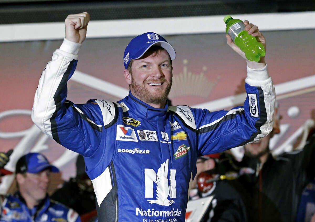 Dale Earnhardt Jr celebrates in Victory Lane after winning the first of two qualifying races for the Daytona 500 NASCAR Sprint Cup series auto race at Daytona International Speedway in Daytona Beach, Fla., Thursday, Feb. 19, 2015. (AP Photo/John Raoux)