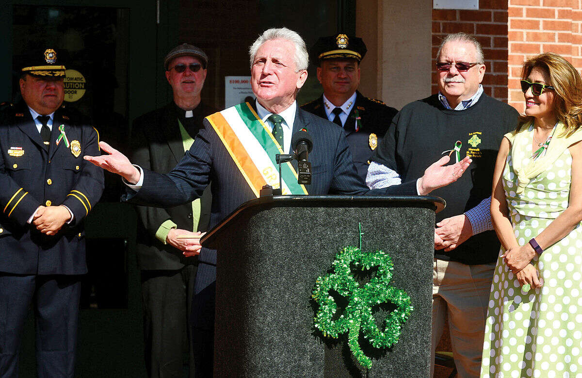 Hour photo / Erik Trautmann Norwalk mayor Harry Rilling greets the crowd as the Norwalk Police Department Emerald League held a ceremony in front of police headquarters before the first St. Patrick's Day parade Thursday.