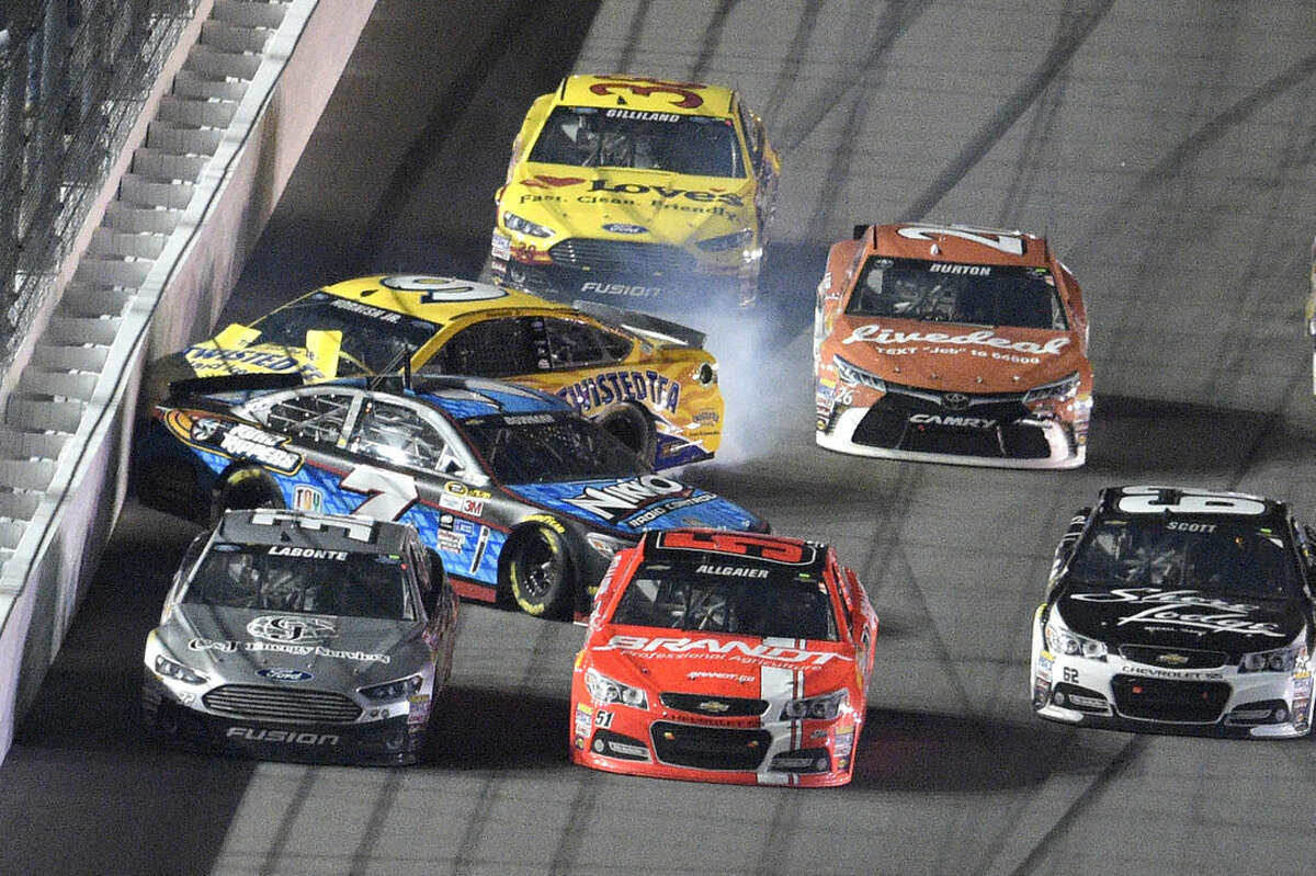 Sam Hornish Jr. (9) and Alex Bowman (7) hit the wall along the front stretch during the second of two qualifying races for the Daytona 500 NASCAR Sprint Cup series auto race at Daytona International Speedway, Thursday, Feb. 19, 2015, in Daytona Beach, Fla. (AP Photo/Phelan M. Ebenhack)