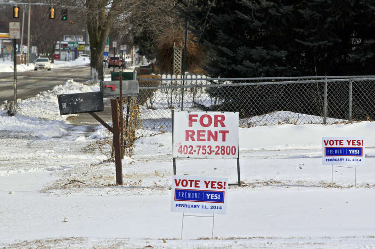 In this Thursday, Feb. 6, 2014 photo, yard signs urging voters to vote "Yes," stand in Fremont, Neb. Voters in the eastern Nebraska city of Fremont will decide in a special election on Tuesday, Feb. 11, whether to drop housing restrictions aimed at reducing illegal immigration they had approved in 2010. The city leaders scheduled the special election because of concerns the housing restrictions could cost them millions in federal grants and lead to more lawsuits against the city. (AP Photo/Nati Harnik)