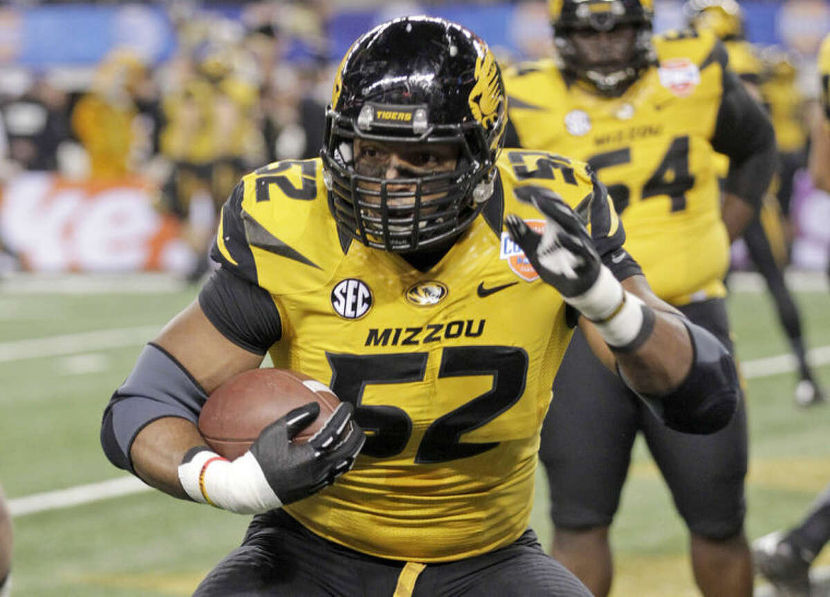 FILE - In this Jan. 3, 2014 file photo, Missouri defensive lineman Michael Sam (52) warms up before the Cotton Bowl NCAA college football game against Oklahoma State, in Arlington, Texas. Michael Sam hopes his ability is all that matters, not his sexual orientation. Missouri's All-America defensive end came out to the entire country Sunday night, Feb. 9, 2014, and could become the first openly gay player in America's most popular sport. (AP Photo/Tim Sharp, File)