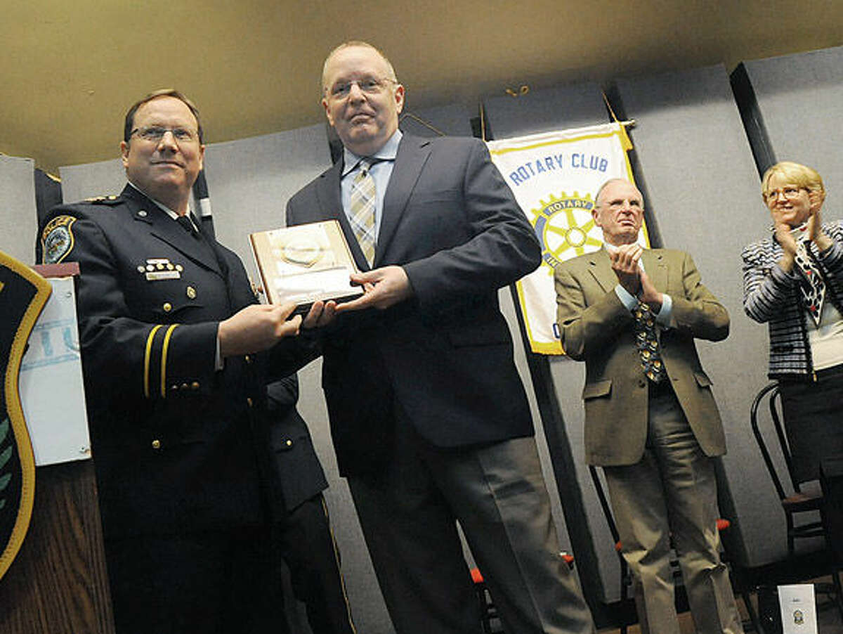 Wilton Police Chief Robert Crosby awards Officer John Godfrey with the Officer of the Year award on Monday.