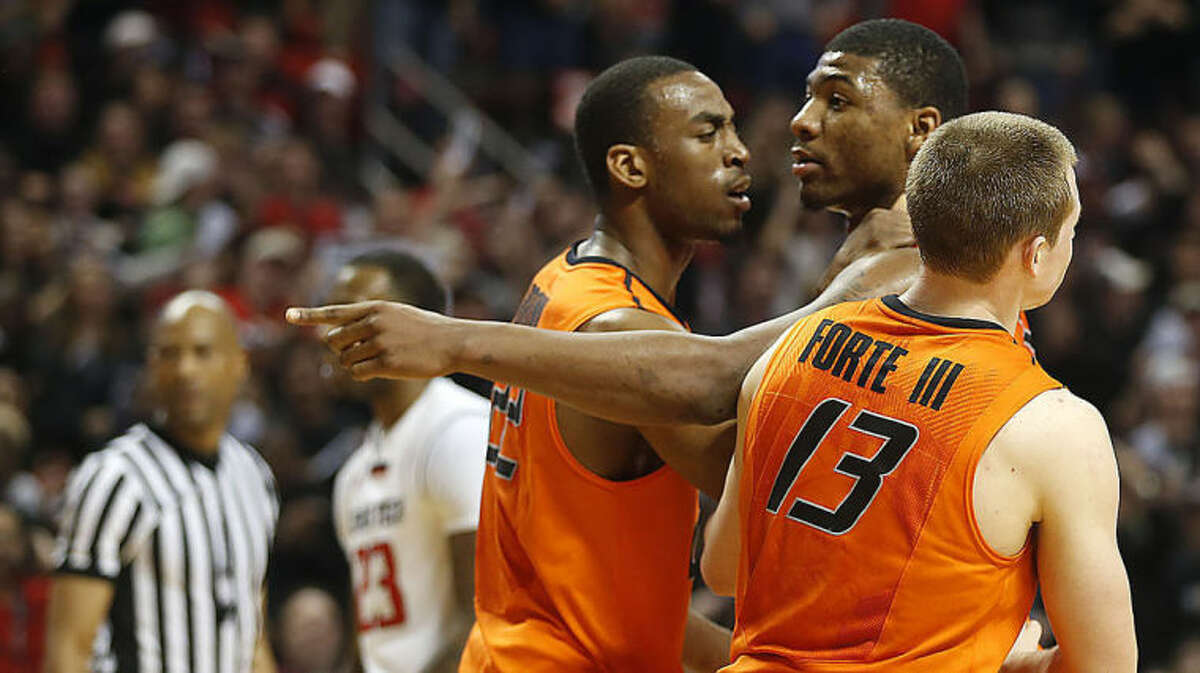 Oklahoma State's Markel Brown(22) and Phil Forte(13) hold Marcus Smart(33) after Smart shoved a fan during their NCAA college basketball game in Lubbock, Texas, Saturday, Feb, 8, 2014. (AP Photo/Lubbock Avalanche-Journal, Tori Eichberger) ALL LOCAL TV OUT
