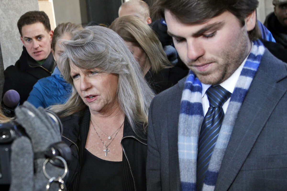Former first lady Maureen McDonnell leaves federal court with her son Bobby after being sentenced to one year and one day on corruption charges in Richmond, Va., Friday, Feb. 20, 2015. Fighting back tears, McDonnell apologized to her family and Virginians and said she takes full responsibility. (AP Photo/Steve Helber)