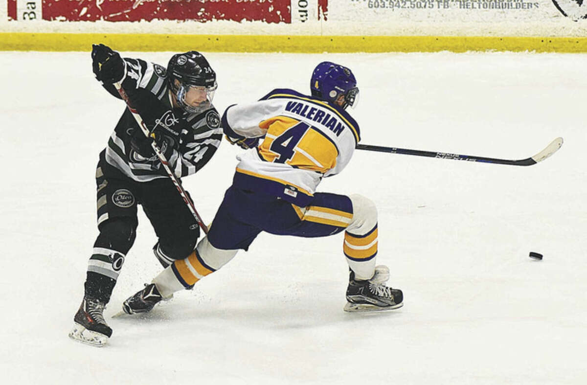 Hour photo/John Nash Connecticut Oilers skater Alex Wilkinson, left, finds himself on the wrong side of New Hampshire Junior Monarchs player CJ Valerian during their EHL semifinal series at the Tri-Town Arena in Hooksett, N.H. The Monarchs won Sunday's second game 5-1 to sweep the best of three series 2-0.