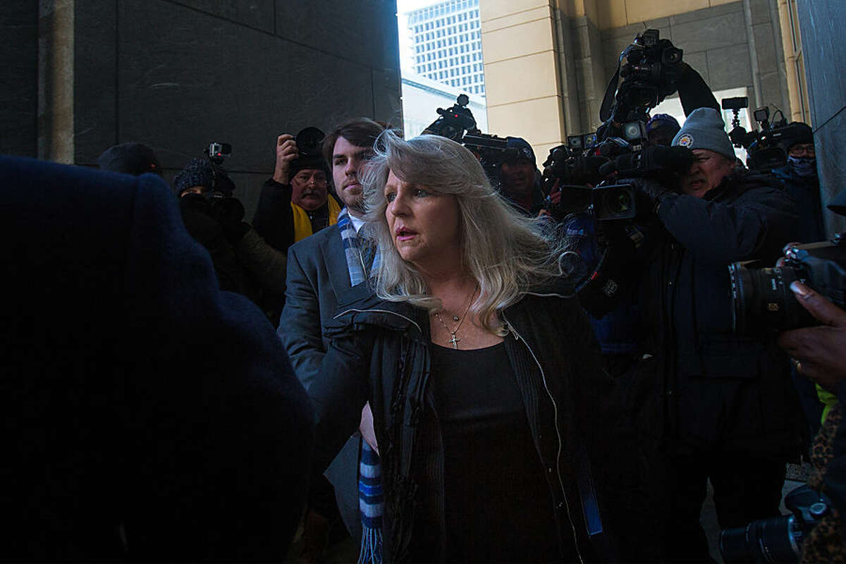 Former Virginia first lady Maureen McDonnell arrives at federal court with her son Bobby, left, for her sentencing in Richmond, Va., Friday, Feb. 20, 2015. Federal prosecutors have recommended an 18-month prison term, six months less than former Gov. Bob McDonnell received when he was convicted on 11 counts last month. (AP Photo/The Virginian-Pilot, Hyunsoo Leo Kim) MAGS OUT