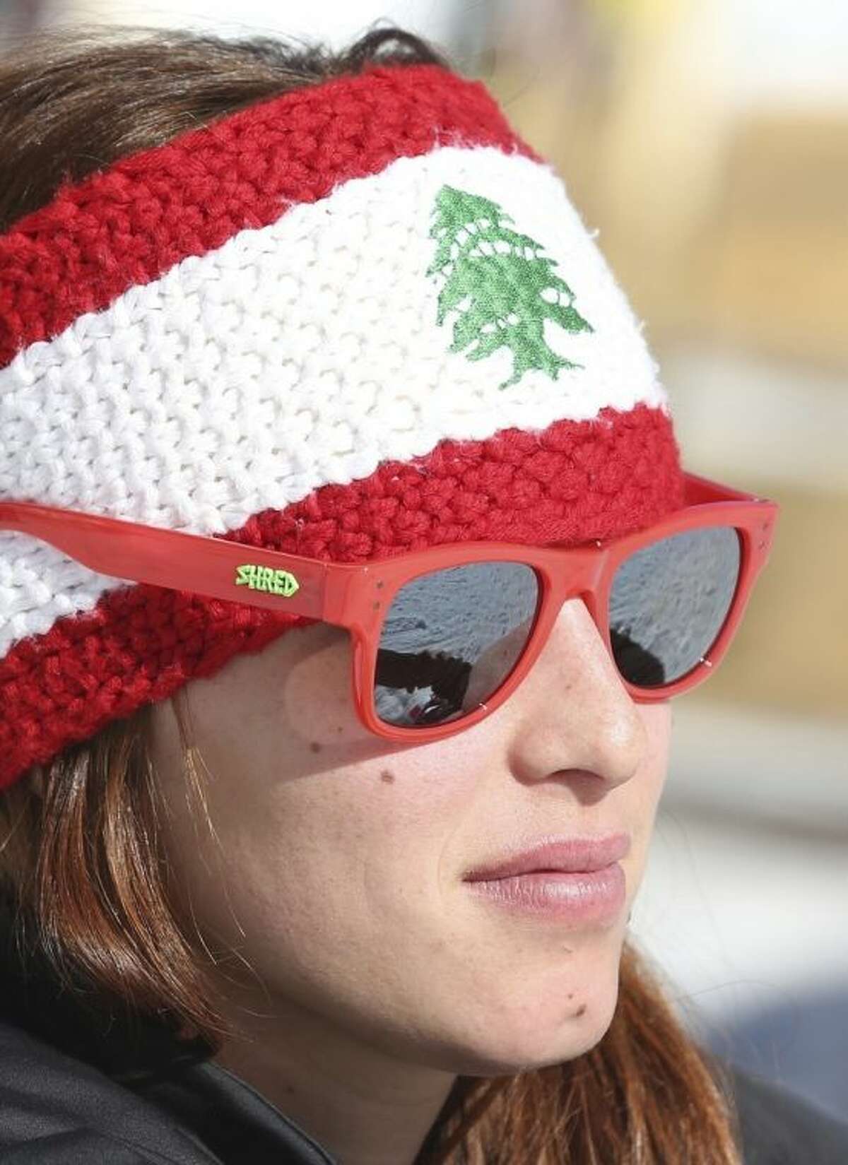 Lebanon's Jacky Chamoun sits near the alpine ski course finish area at the Sochi 2014 Winter Olympics, Thursday, Feb. 13, 2014, in Krasnaya Polyana, Russia. The Lebanese Olympic skier seen topless in revealing photographs and a video that circulated on the Internet says her country's sports officials are "on my side." Three years ago, Chamoun posed for a calendar photo shoot. Behind-the-scenes footage recently was posted online, and Lebanon's Sports and Youth Minister reportedly ordered an investigation. (AP Photo/Luca Bruno)