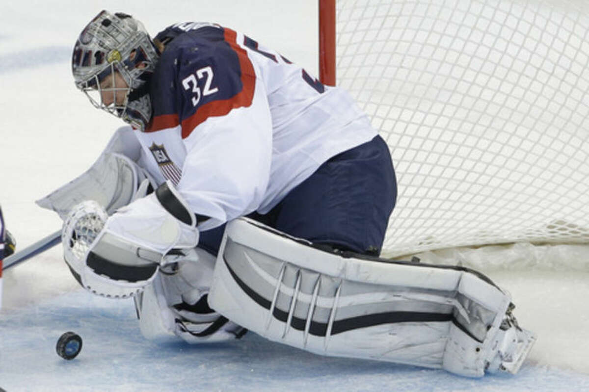 USA goaltender Jonathan Quick dives on the puck during the second period of the game against Slovakia during the 2014 Winter Olympics men's ice hockey tournament at Shayba Arena, Thursday, Feb. 13, 2014, in Sochi, Russia. (AP Photo/Matt Slocum)
