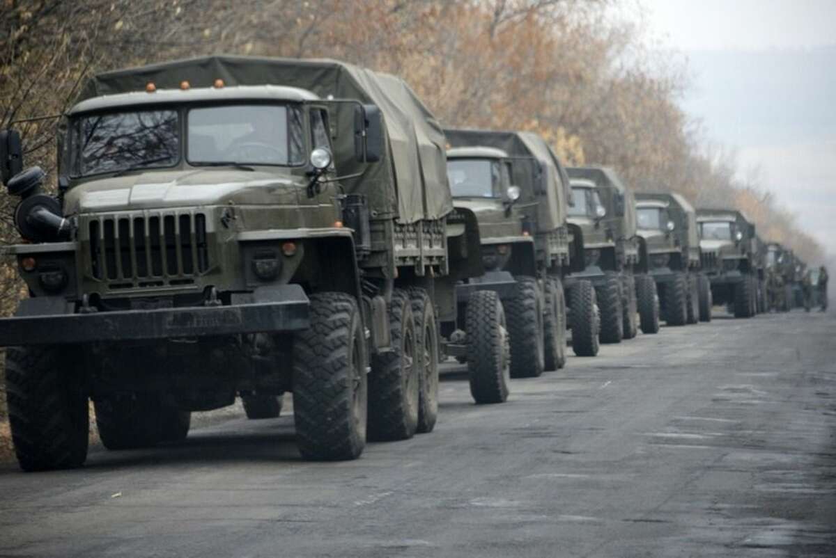 FILE- In this file photo taken Saturday, Nov. 8, 2014, Unmarked military vehicles parked on a road outside the separatist rebel-held eastern Ukrainian town of Snizhne, 80 kilometers (50 miles) from Donetsk, eastern Ukraine. Russia has denied it is sending arms and troops to support the separatists in Ukraine, but dozens of soldiers have been reported killed during drills in the Rostov region of southern Russia, but rights groups have actually attributed the deaths to the conflict over the border in Ukraine. (AP Photo/Mstyslav Chernov, file)