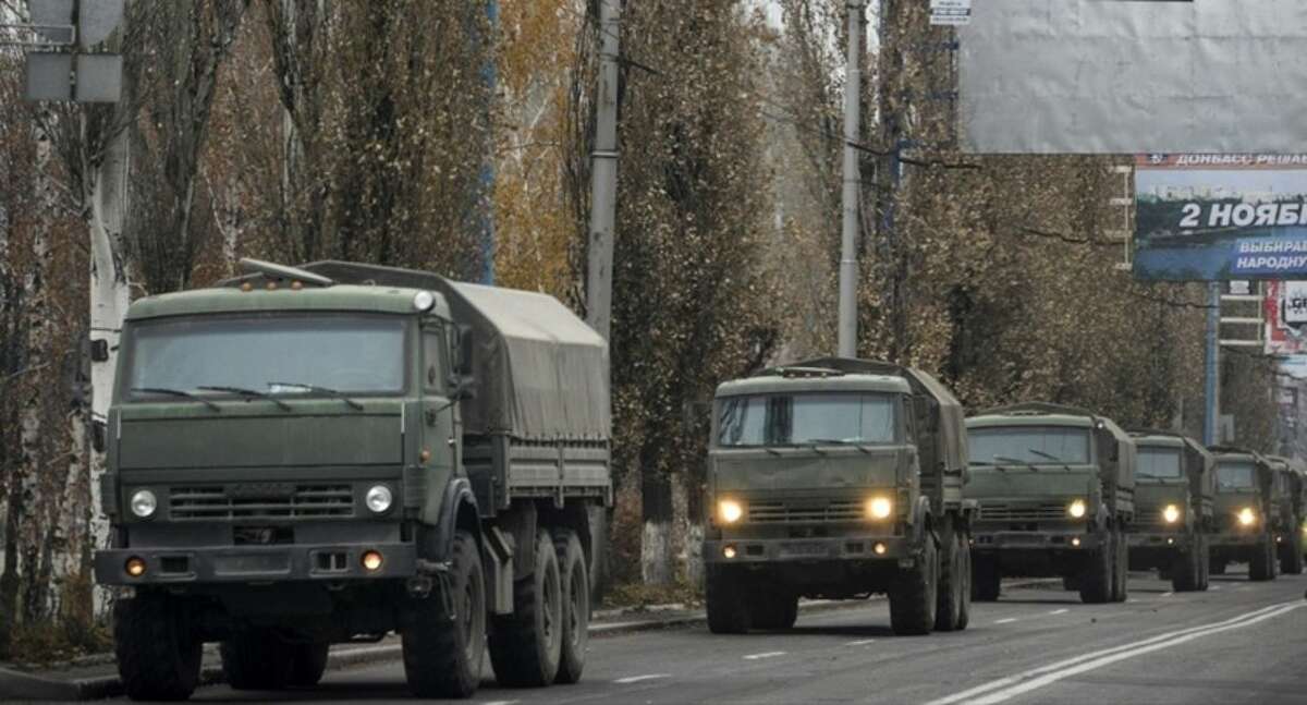 FILE- In this file photo dated Tuesday, Nov. 11, 2014, A convoy of unmarked military vehicles in Donetsk, eastern Ukraine. Russia has denied it is sending arms and troops to support the separatists in Ukraine, but dozens of soldiers have been reported killed during drills in the Rostov region of southern Russia, but rights groups have actually attributed the deaths to the conflict over the border in Ukraine. (AP Photo/Mstyslav Chernov, file)
