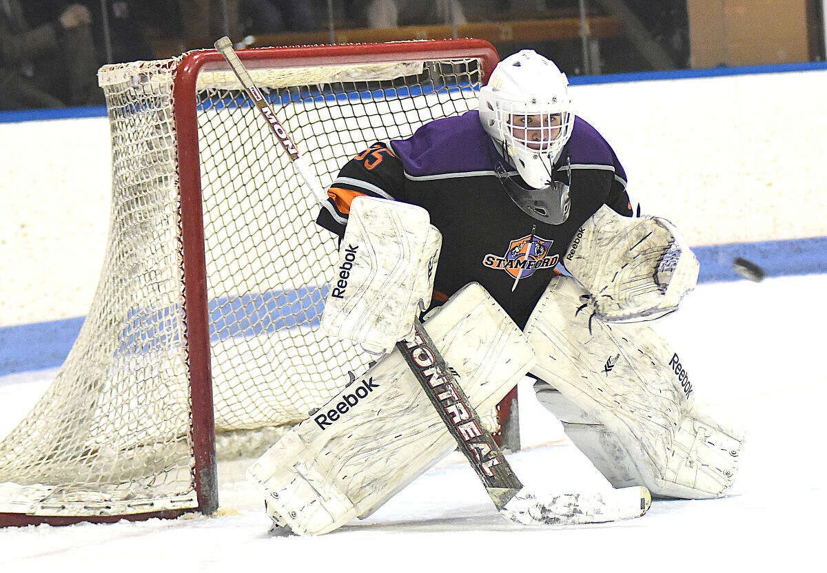 Christian Compolattaro of Westhill-Stamford keeps his eye on the puck during Tuesday's CIAC Division 3 semifinal against New Fairfield-Immaculate at Yale University's Ingalls Rink.