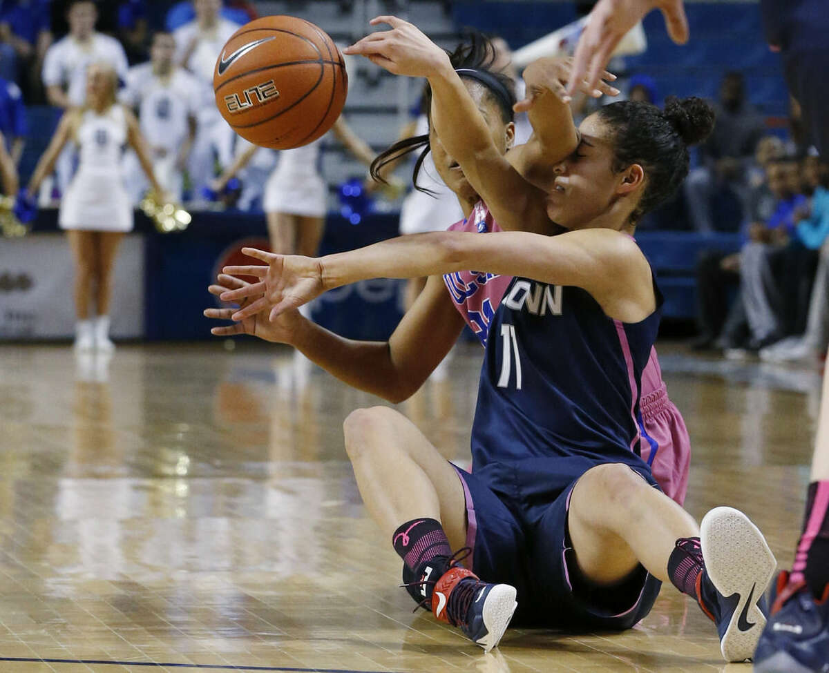 Connecticut guard Kia Nurse (11) is fouled by Tulsa guard Ashley Clark, left, as they reach for the ball in the second half of an NCAA college basketball game in Tulsa, Okla., Saturday, Feb. 21, 2015. Connecticut won 92-46. (AP Photo/Sue Ogrocki)