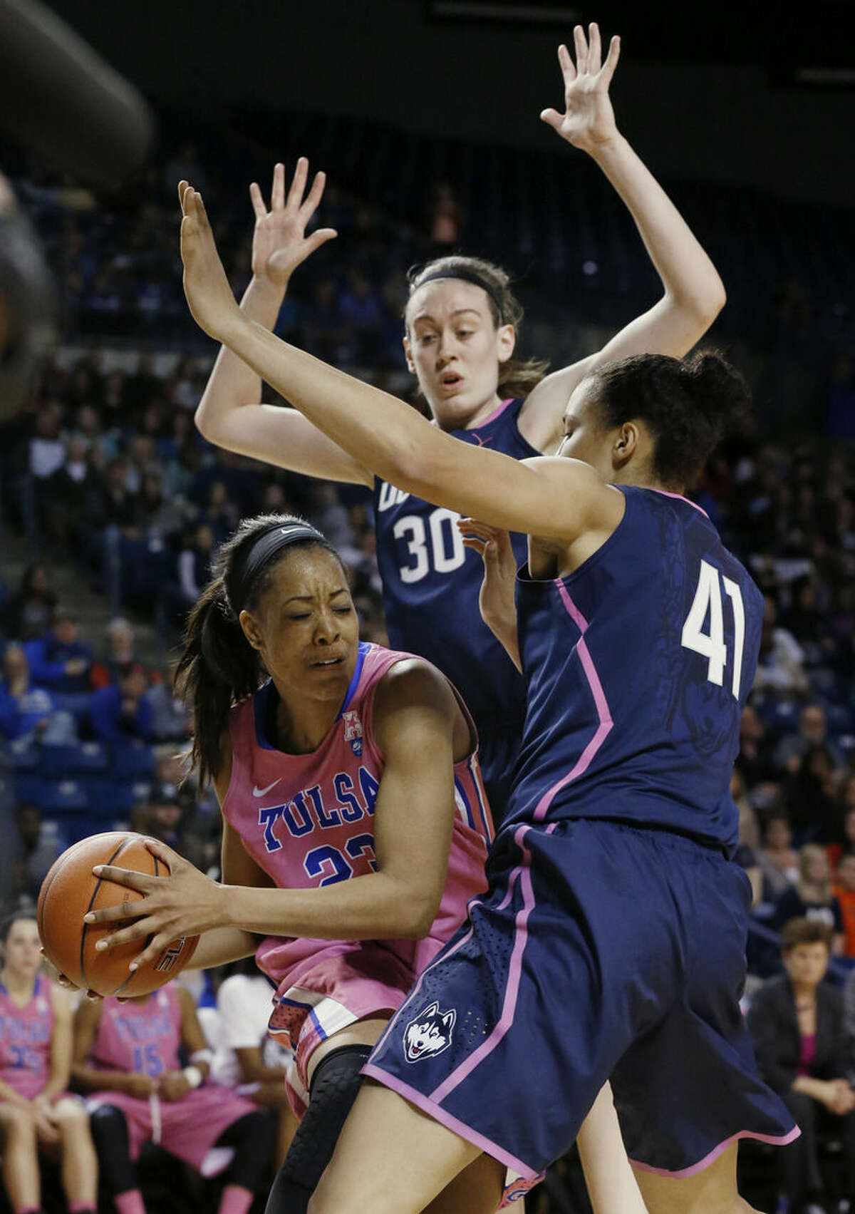 Tulsa guard Ashley Clark (23) is defended by Connecticut forward Breanna Stewart (30) and center Kiah Stokes (41) in the second half of NCAA college basketball game in Tulsa, Okla., Saturday, Feb. 21, 2015. Connecticut won 92-46. (AP Photo/Sue Ogrocki)