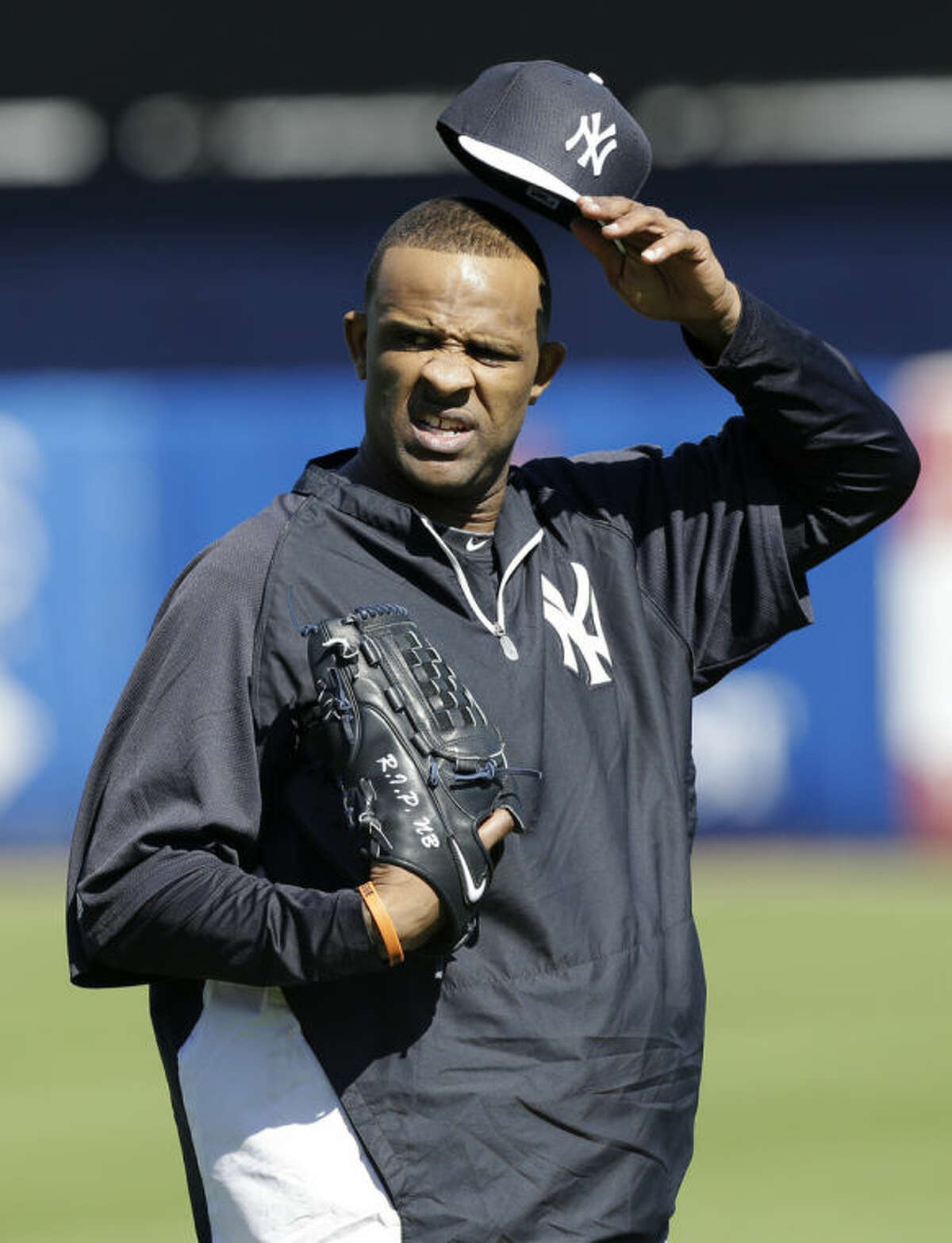 New York Yankees starting pitcher CC Sabathia waits to throw in the outfield during spring training baseball practice Friday, Feb. 14, 2014, in Tampa, Fla. (AP Photo/Charlie Neibergall)