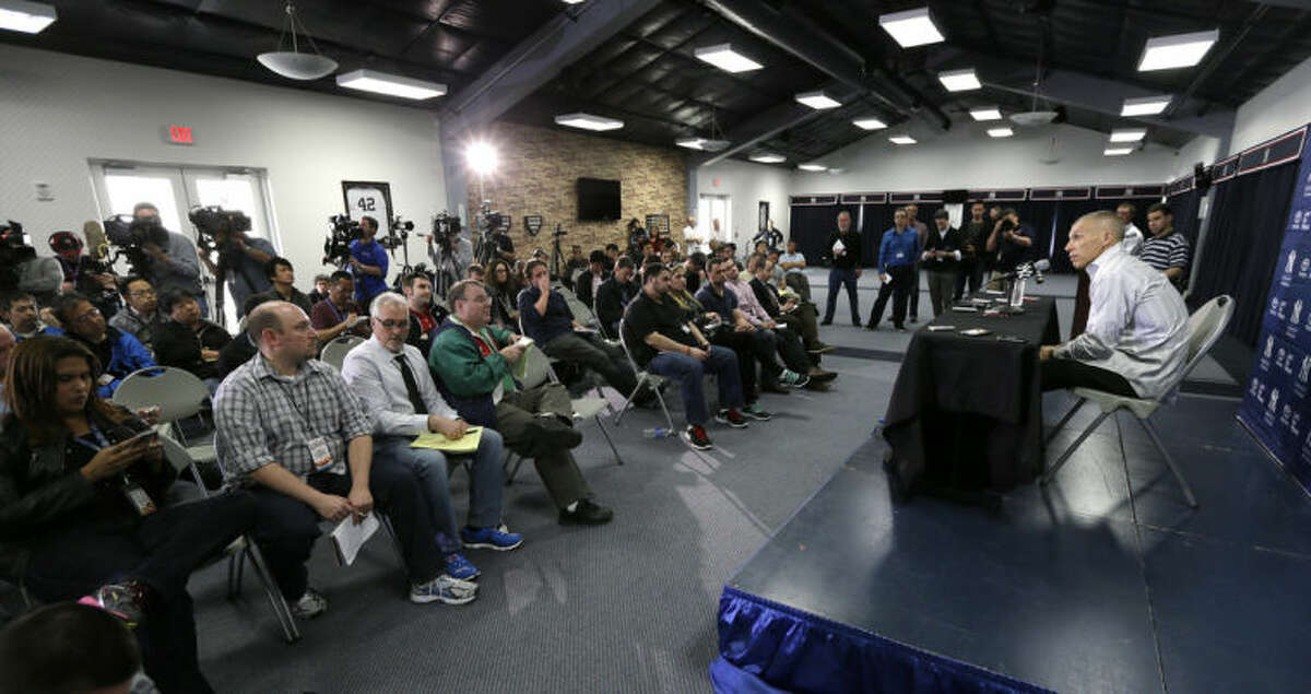 New York Yankees manager Joe Girardi, right, speaks during a news conference following a spring training baseball practice Friday, Feb. 14, 2014, in Tampa, Fla. (AP Photo/Charlie Neibergall)