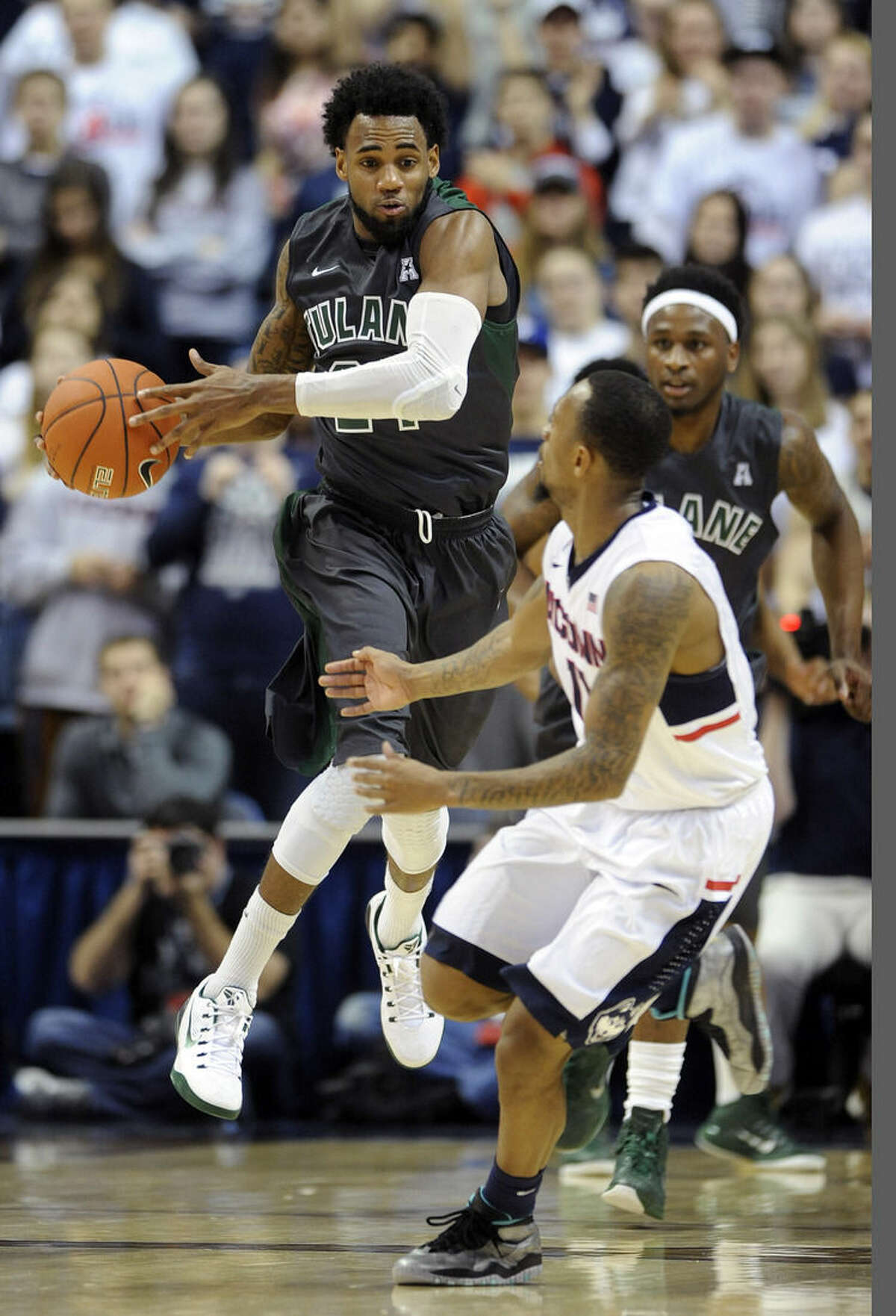 Connecticut's Ryan Boatright, right, guards Tulane's Jay Hook, left, during the first half of an NCAA college basketball game, Sunday, Feb. 22, 2015, in Storrs, Conn. (AP Photo/Fred Beckham)