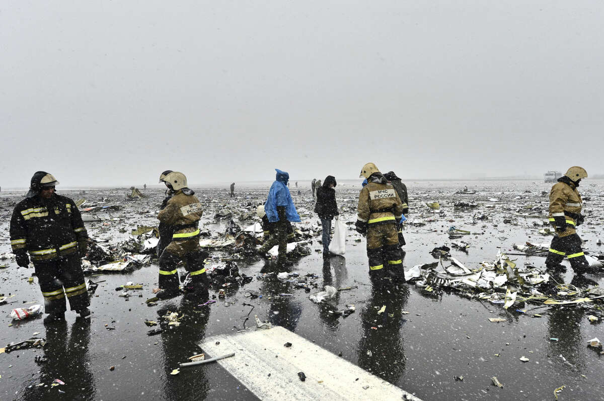 Russian Emergency Ministry employees are seen among the wreckage of a crashed plane at the Rostov-on-Don airport, about 950 kilometers (600 miles) south of Moscow, Russia Saturday, March 19, 2016. A Dubai airliner crashed and caught fire early Saturday while landing in strong winds in the southern Russian city of Rostov-on-Don, officials said. (AP Photo)