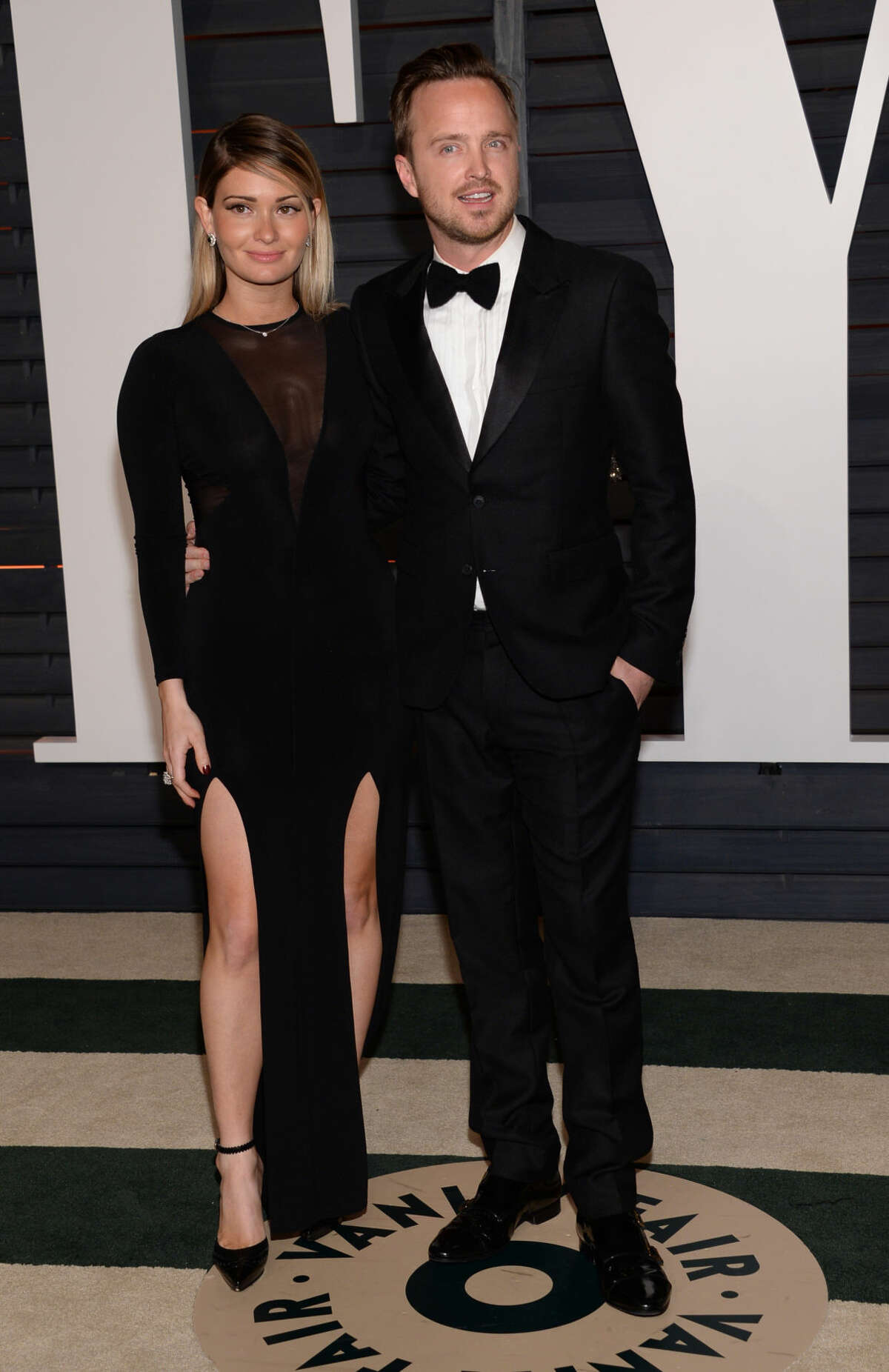 Lauren Parsekian, left, and Aaron Paul arrive at the 2015 Vanity Fair Oscar Party on Sunday, Feb. 22, 2015, in Beverly Hills, Calif. (Photo by Evan Agostini/Invision/AP)
