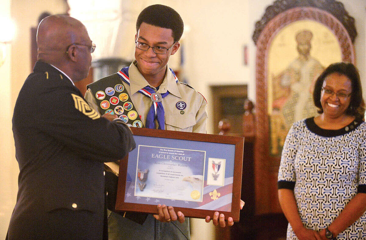 Hour photo / Erik Trautmann Sean Walters is honored during the Boy Scout Eagle Court of Honor ceremony at St. George Greek Orthodox Church where Walters was awarded the Eagle Scout Badge with the help of his family including his father Greg Walters, mother Dee Walters and other dignitaries Saturday afternoon.