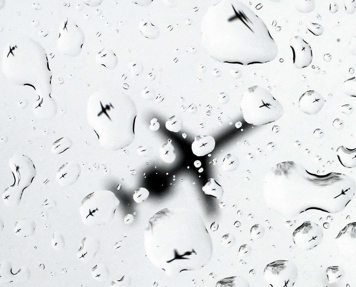 As a spring storm makes its way through the region, a plane is refracted in the raindrops on a vehicle window as it approaches the Dane County Regional airport in Madison, Wis. Wednesday, March 23, 2016. The storm is expected to bring gusty winds and heavy snow to parts of the Midwest on Thursday. Wisconsin Gov. Scott Walker has declared a state of emergency as the snowstorm bears down on his state. (John Hart/Wisconsin State Journal via AP) MANDATORY CREDIT