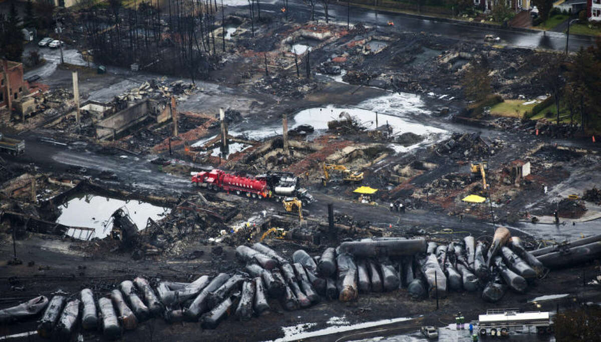 AP Photo/The Canadian Press, Paul Chiasson, File In this July 9, 2013, file photo, workers comb through debris after an oil train derailed and exploded in the town of Lac-Megantic, Quebec, killing 47 people. In response to Lac-Megantic, the National Transportation Safety Board and Transportation Safety Board of Canada in January 2014, called on regulators to require railroads to take stock of the risks along certain oil train routes and change them if needed.