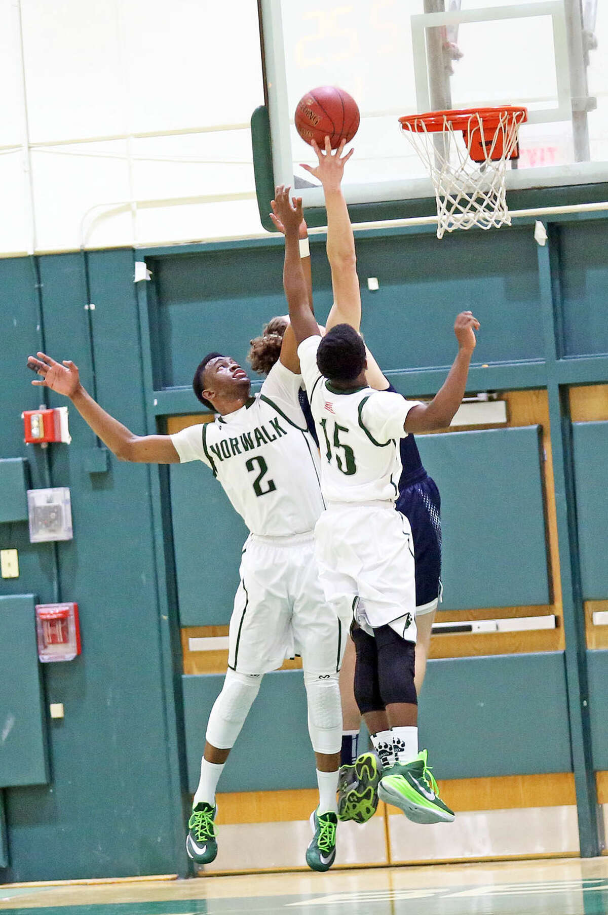 Norwalk's #2, Zaire Wilson, goes for the rebound during a home game against Staples Monday evening. Hour Photo / Danielle Calloway