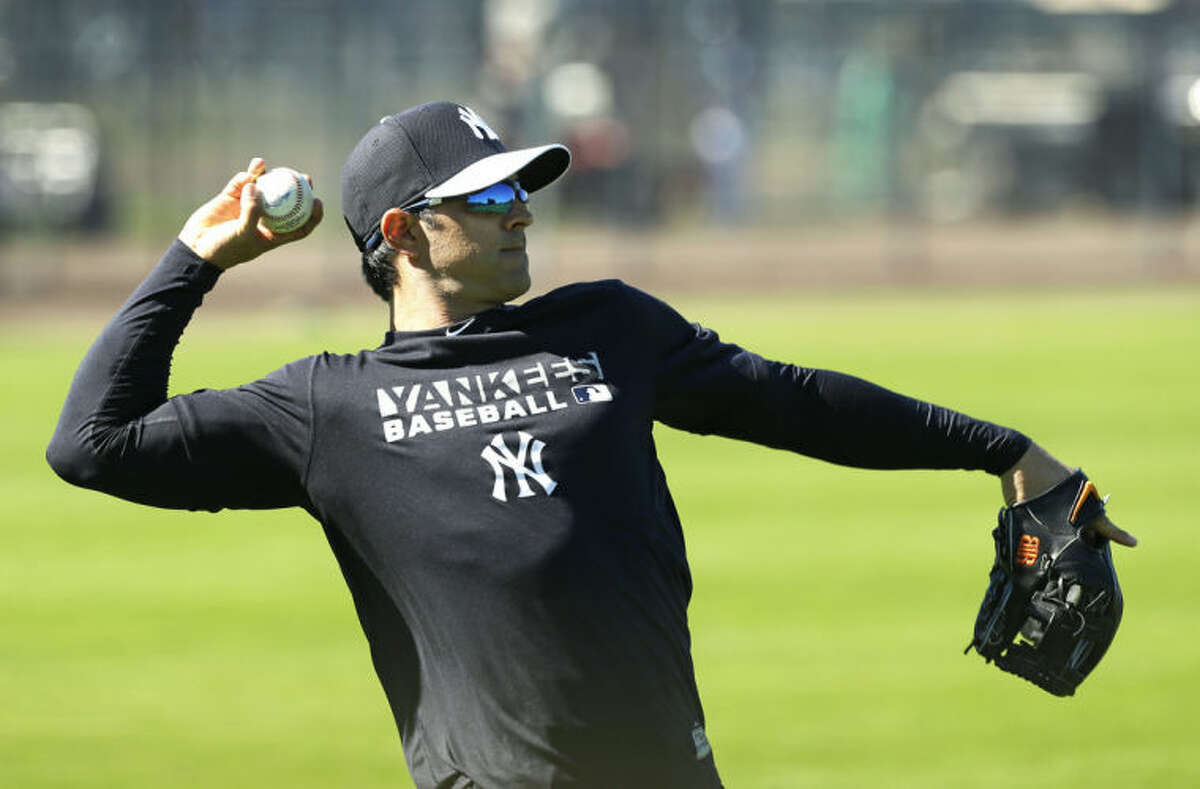 New York Yankees infielder Brian Roberts throws in the outfield during spring training baseball practice, Monday, Feb. 17, 2014, in Tampa, Fla. (AP Photo/Charlie Neibergall)