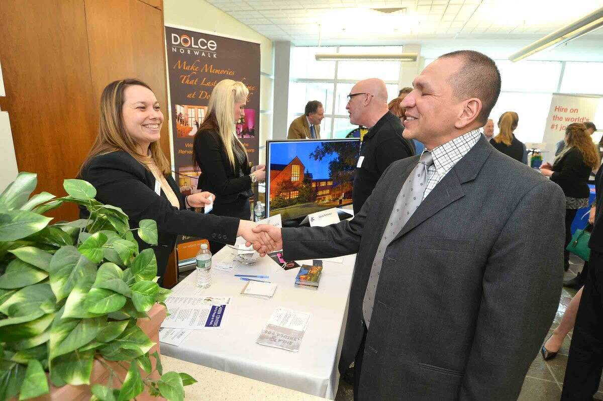 Hour Photo/Alex von Kleydorff Jay Desiderio talks with Dolce Center's Krista Farrell at the Multi Chamber Expo at NCC