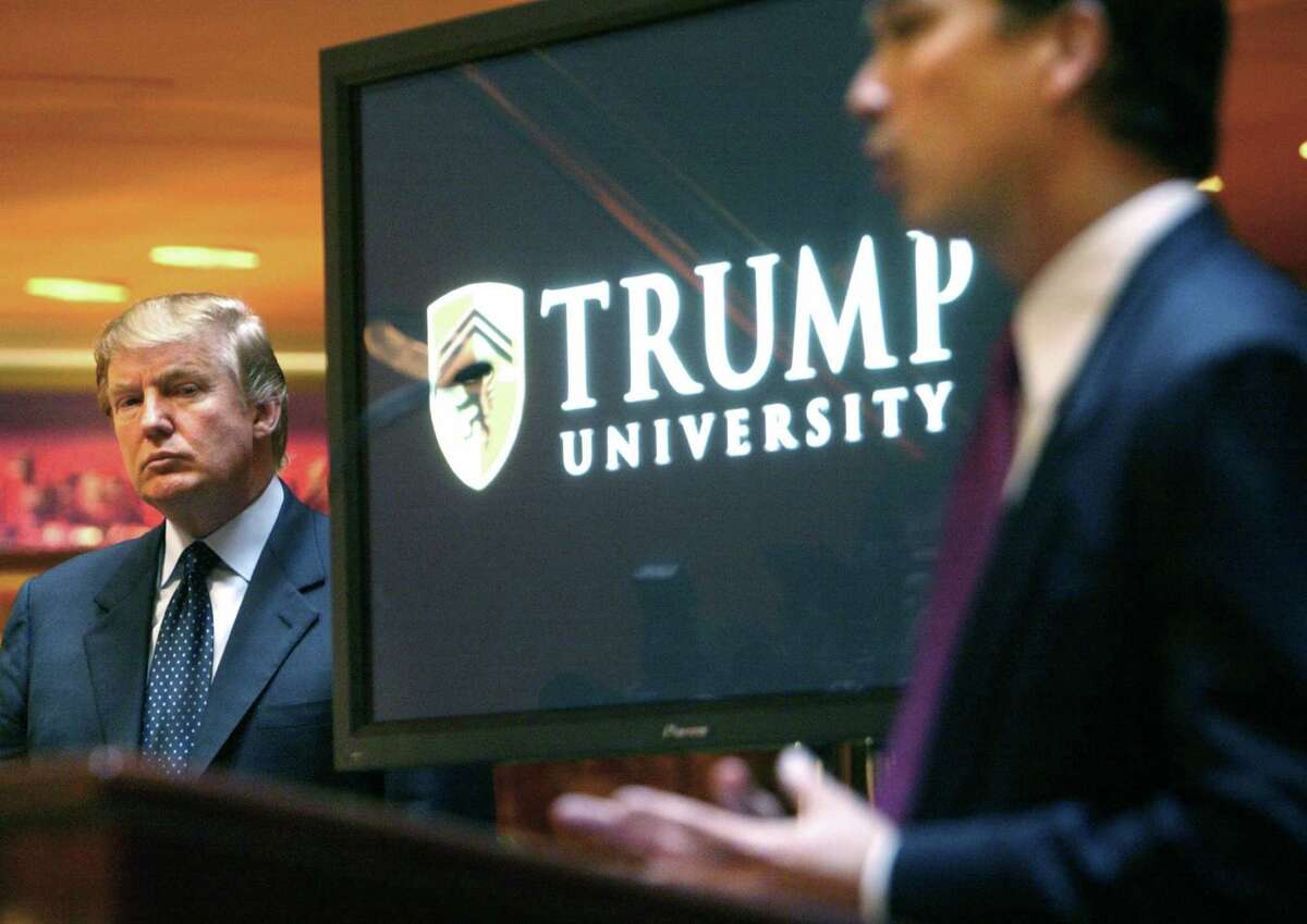 ﻿Donald Trump, left, listens as he is introduced at a 2005 news conference in New York where he announced the establishment of Trump University.﻿