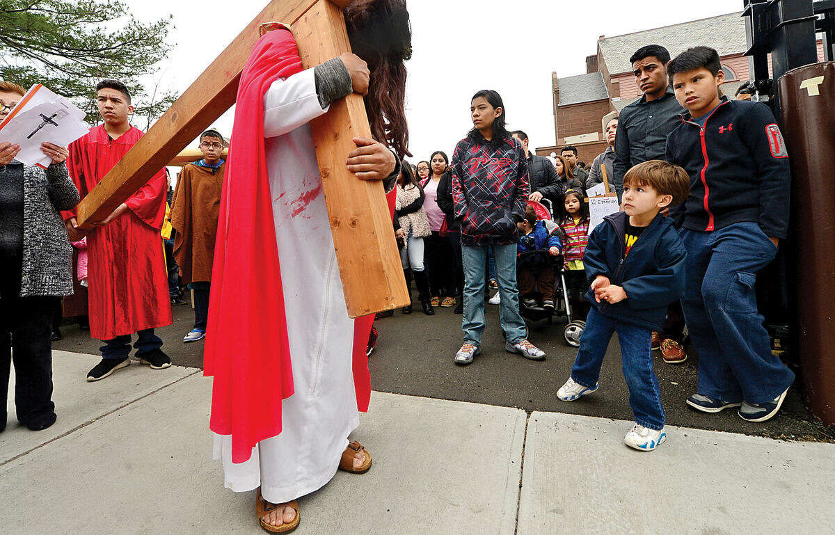 Hour photo / Erik Trautmann Darwin Aplacano portrays Jesus as nearly 100 parishioners of St. Joseph Church observe the Living Stations of the Cross at the church in South Norwalk on Good Friday.