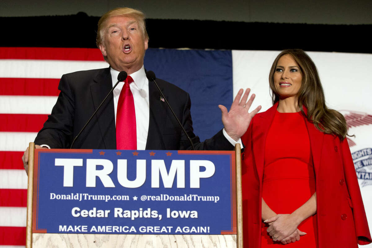 FILE - In this Feb. 1, 2016 file photo, Republican presidential candidate Donald Trump, accompanied by his wife Melania Trump, speaks during a campaign event in Cedar Rapids, Iowa. Ted Cruz accused Trump of stoking false rumors about his personal life on Friday, March 25, 2016, charging that the billionaire businessman and GOP front-runner is trafficking in “sleaze” and “slime.” (AP Photo/Mary Altaffer, File)