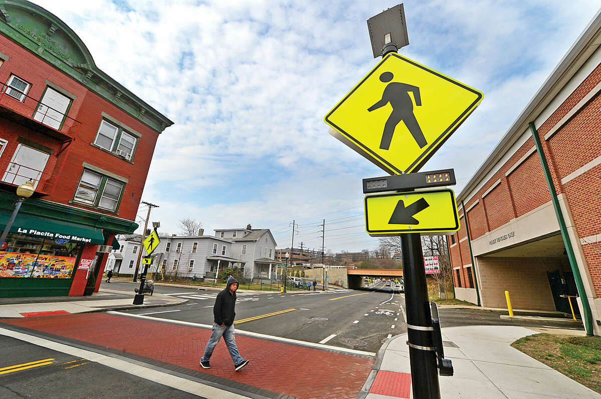 Hour photo / Erik Trautmann Norwalk Department of Public Works adds flashing beacons to nearly a dozen crosswalks in Norwalk including the intersection of Chesnut and Monroe Streets.