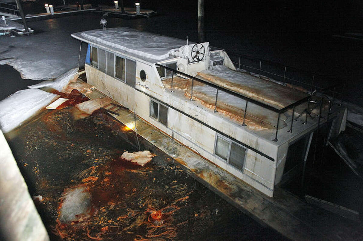 The scene of a sinking boat at Oyster Bend Marina in Norwalk Friday evening. Hour Photo / Danielle Calloway