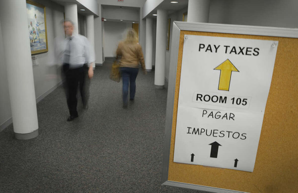 Hour Photo/Alex von Kleydorff A sign directs people to the Tax Collectors office in Norwalk City Hall on Monday, the last day to pay property taxes without penalties