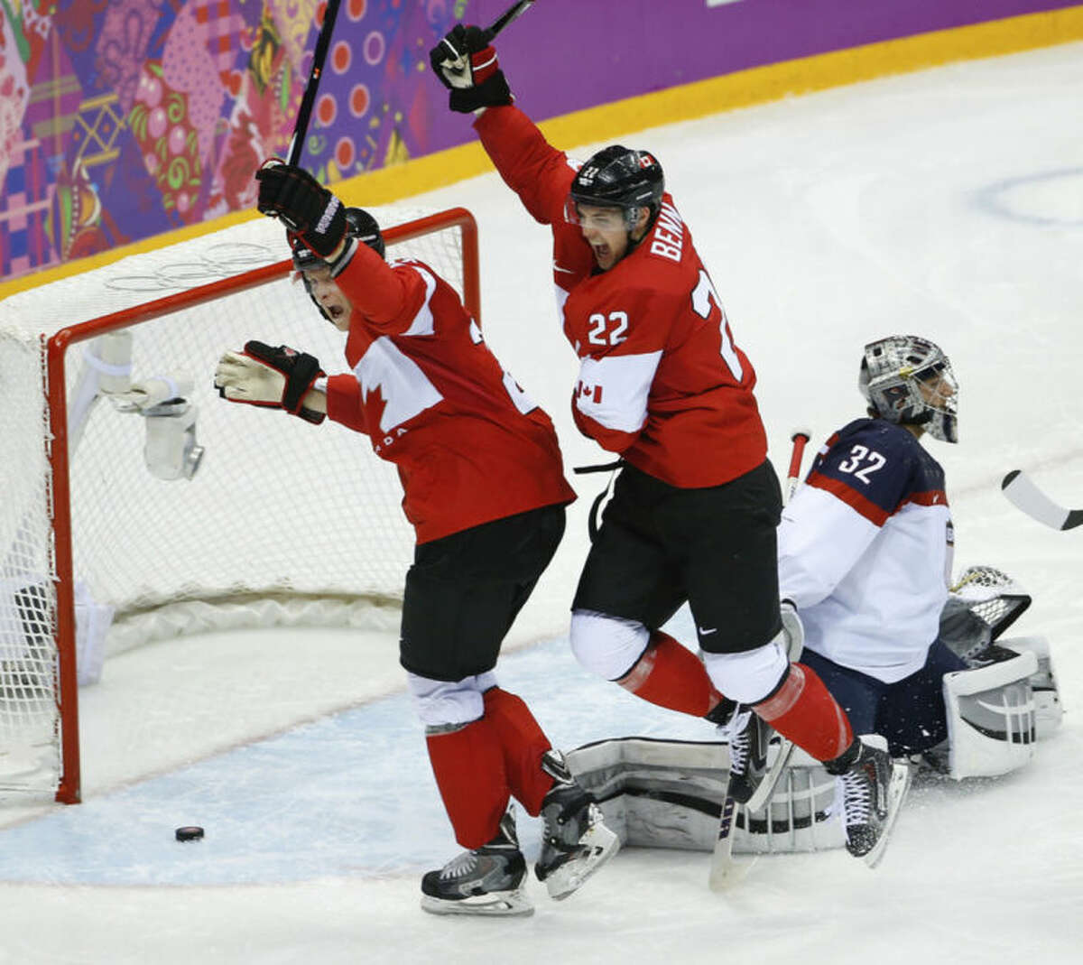 Canada forward Benn Jamie (22) celebrates his goal against USA goaltender Jonathan Quick (32) during the second period of the men's semifinal ice hockey game at the 2014 Winter Olympics, Friday, Feb. 21, 2014, in Sochi, Russia. (AP Photo/Matt Slocum)