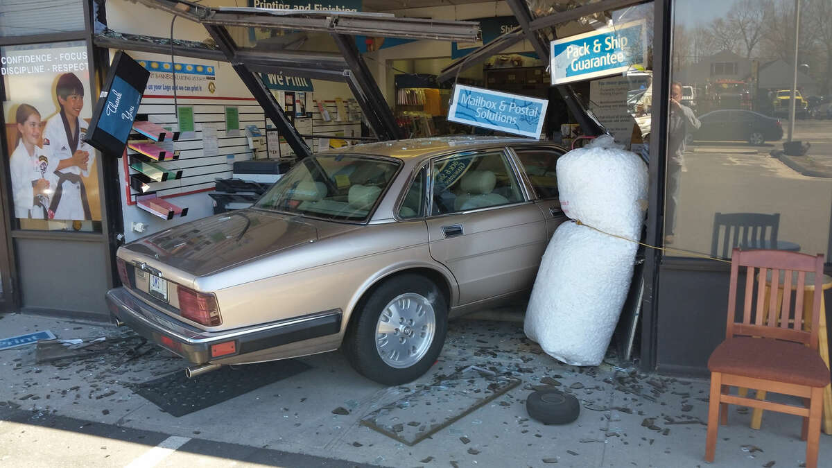 Hour photo/Alex von Kleydorff A car crashed into the UPS Store at 304 Main Ave. in Norwalk on Wednesday afternoon. No serious injuries were reported.