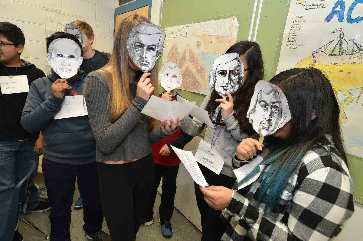 Hour Photo/Alex von Kleydorff Students with paper masks as Congressional delegates Charles Coatsworth Pickney, John Rutledge and William Blount discuss if elections for Representatives should be based on population during American History Class with Mark Jackson at Roton School