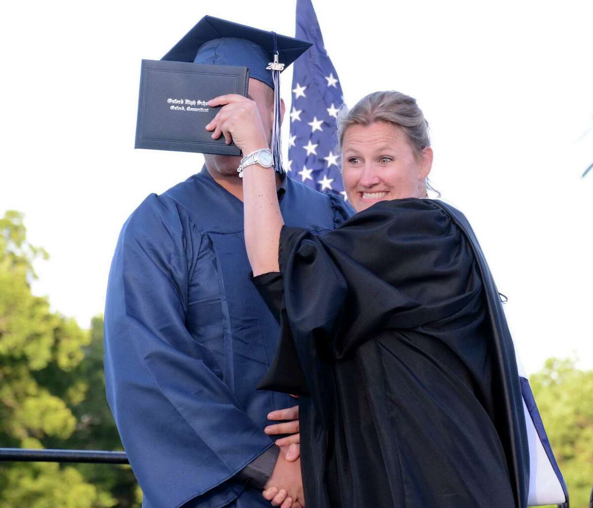 Oxfords Principal, Dorothy Potter, teases graduate Aaron Trelease as he receives his diploma during Oxford High Schools Graduation ceremony in Oxford, Conn. that was held on Friday June 10, 2016.
