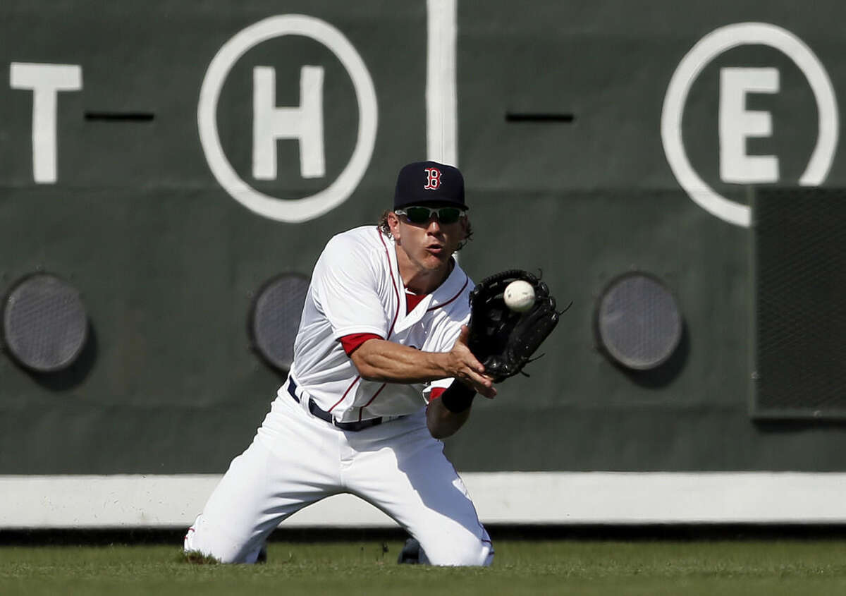 Boston Red Sox left fielder Blake Tekotte goes to his knees to grab a fly out by Miami Marlins' Austin Nola in the seventh inning of a interleague spring training baseball game in Fort Myers Fla., Friday March 6, 2015. (AP Photo/Tony Gutierrez)