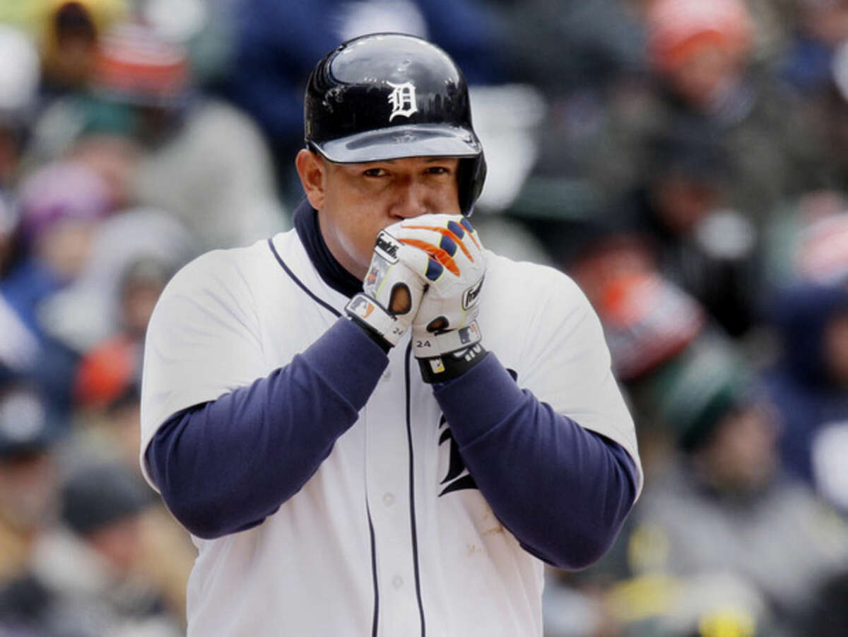 Detroit Tigers' Miguel Cabrera tries to keep his hands warm while batting against the New York Yankees during the fourth inning of a baseball game Saturday, April 9, 2016, in Detroit. (AP Photo/Duane Burleson)