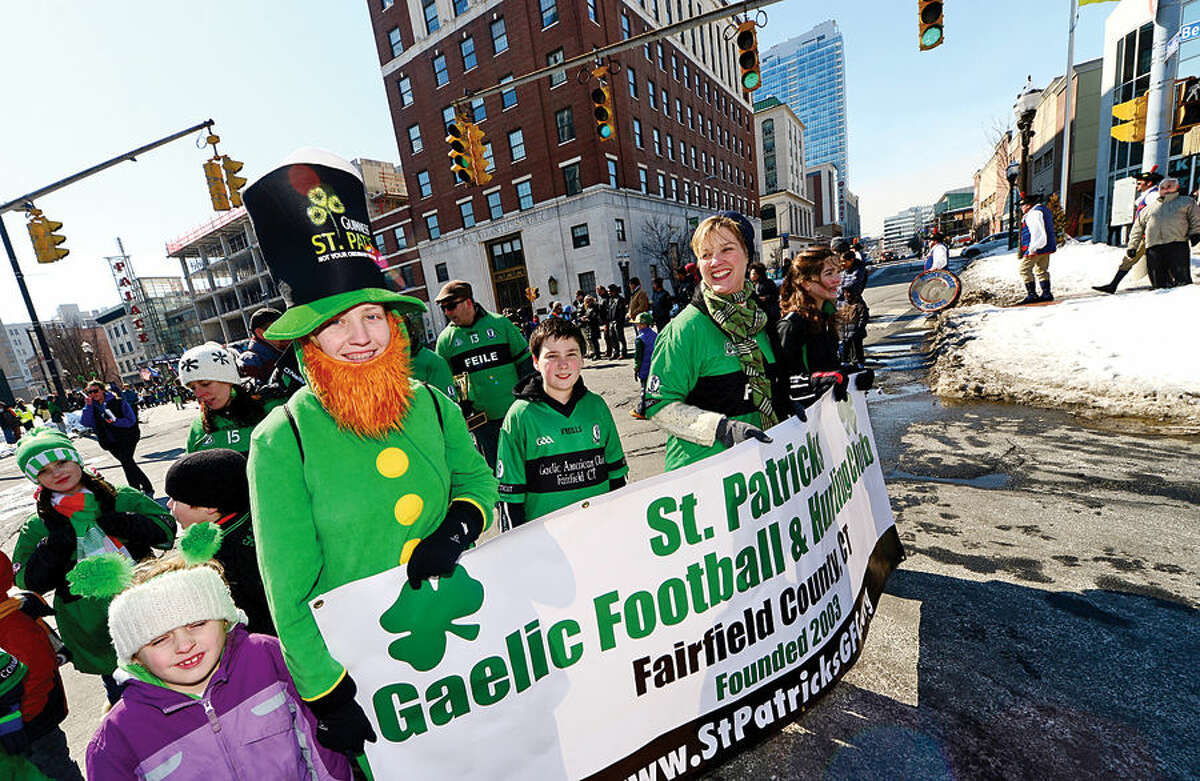 Hour photo / Erik Trautmann Stamford St Patrick's Day Parade participants and local residents enjoy the sunny Saturday afternoon as the procession proceeds down Bedford St.