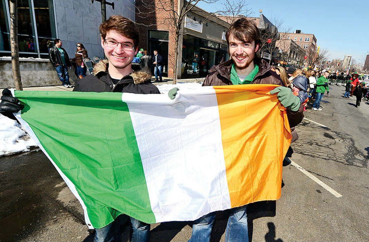 Hour photo / Erik Trautmann Stamford St Patrick's Day Parade participants and local residents including Brian Shaw and Torge Mecker enjoy the sunny Saturday afternoon as the procession proceeds down Bedford St.