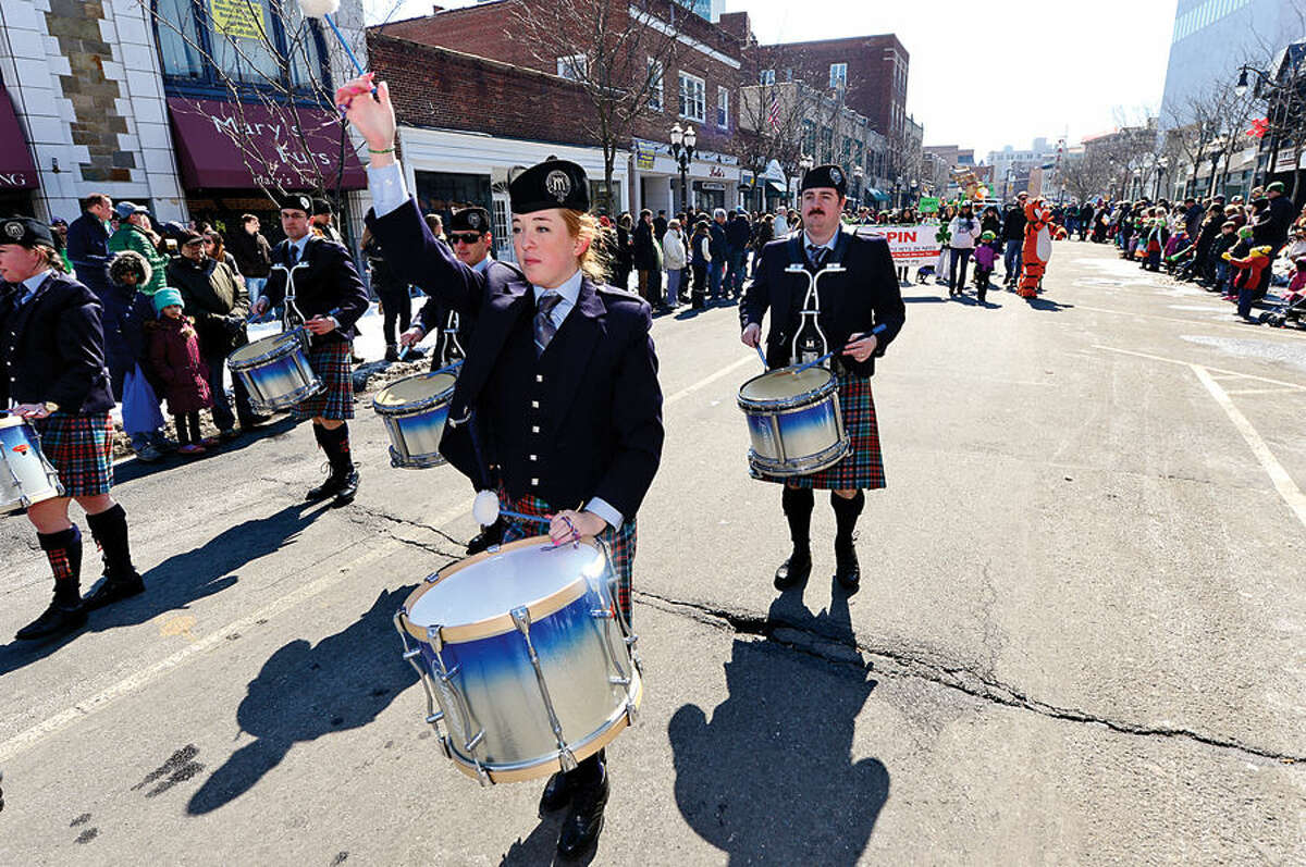 Hour photo / Erik Trautmann Stamford St Patrick's Day Parade participants and local residents including the NY Metro Pipe Band enjoy the sunny Saturday afternoon as the procession proceeds down Bedford St.