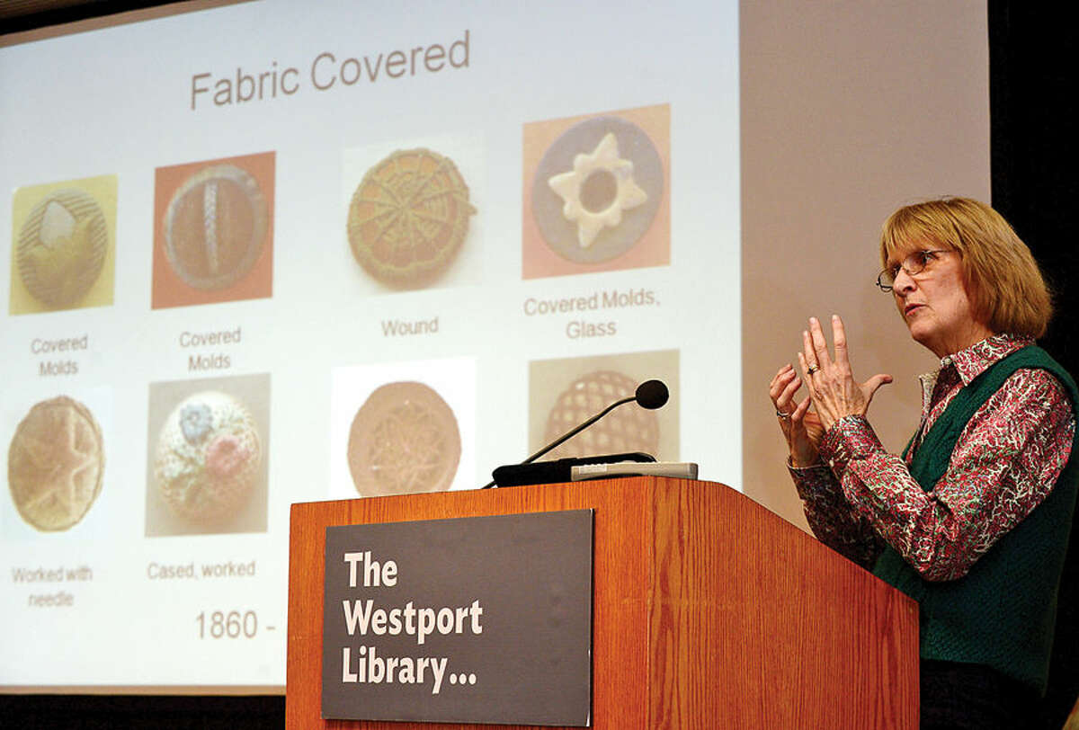 Hour photo / Erik Trautmann Rachel Mercurio, vice president of the Connecticut State Button Society, speaks about Saugatuck button makers in the context of artist Robert L. Lambdin's restored mural, "Saugatuck in the 19th Century" during a presentation at the Westport Public Library Saturday, Women of "Saugatuck@Work"