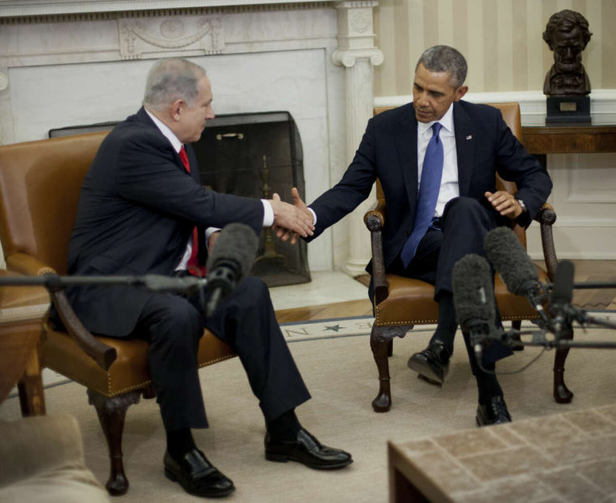 President Barack Obama and Israeli Prime Minister Benjamin Netanyahu shakes hands in the Oval Office of the White House in Washington, Monday, March 3, 2014. Seeking to keep a pair of delicate diplomatic efforts afloat, Obama will personally appeal to Netanyahu to move forward on peace talks with the Palestinians, while also trying to manage Israel's deep suspicion of his pursuit of a nuclear accord with Iran. (AP Photo/Pablo Martinez Monsivais)
