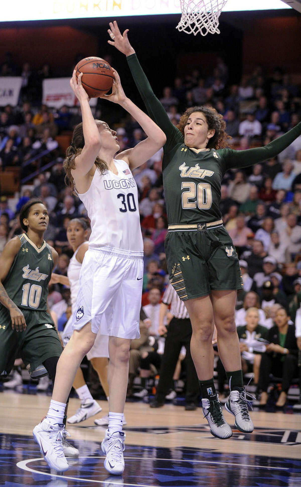 Connecticut's Breanna Stewart (30) is guarded by USF's Laura Ferreira (20) during the first half of an NCAA college basketball game in the finals of the American Athletic Conference tournament in Uncasville, Conn., on Monday, March 9, 2015. (AP Photo/Fred Beckham)